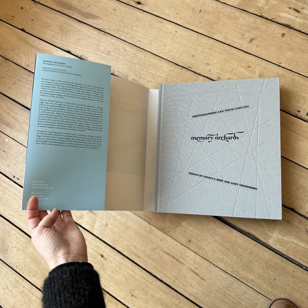 Picture showing Memory Orchards embossed hardback book cover beneath the printed dust jacket.